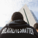 An activist stands during a news conference outside LAPD Headquarters in Los Angeles, California